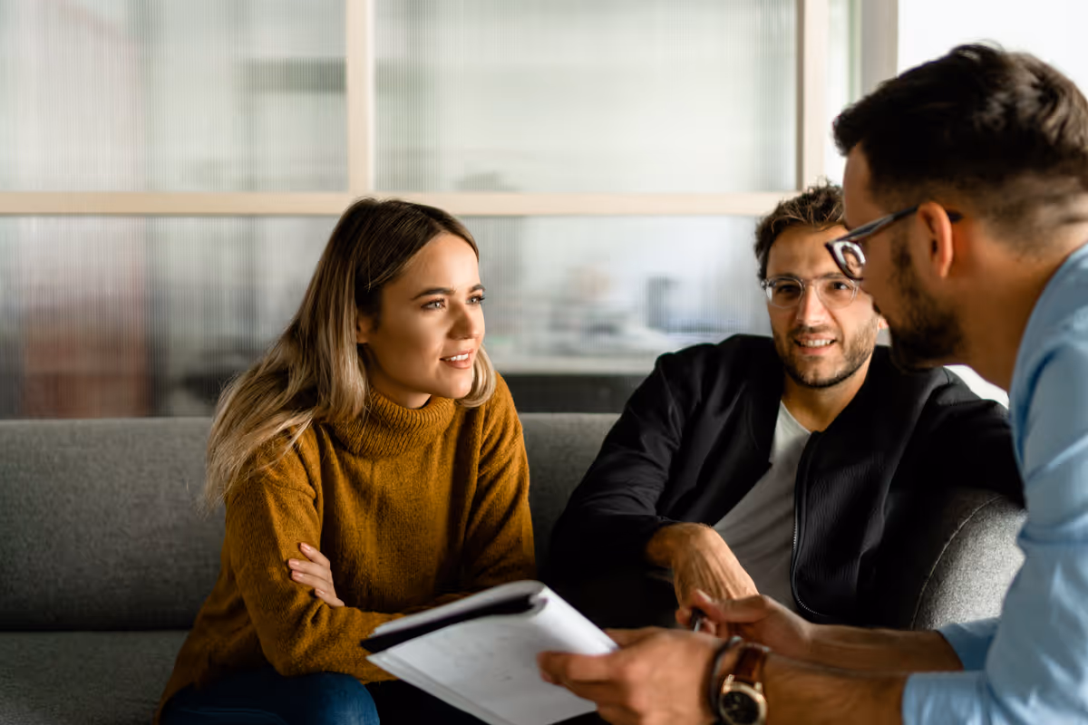 Professionals collaborating over analytics on a laptop